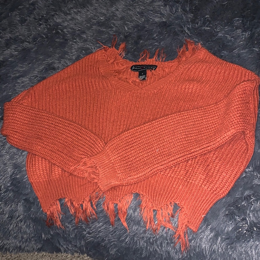 Large burnt orange knitted sweater with fringe at ends